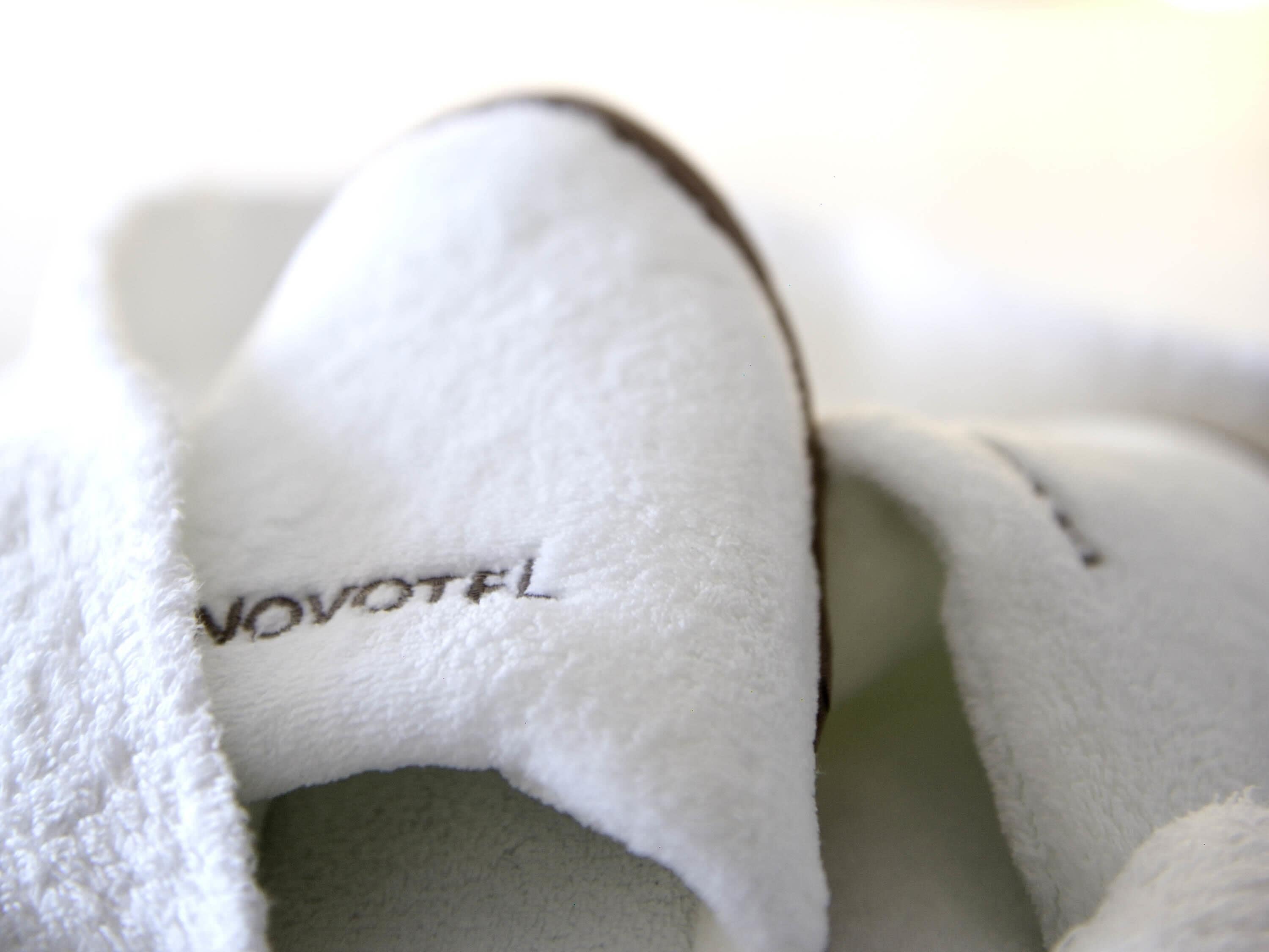 A close-up of a white, plush item with the text 'VOVOTEL' visible.