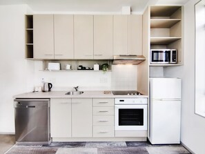 Full-size fridge, microwave, stovetop, coffee/tea maker