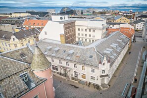A historical building with a central courtyard, a clock tower, and a view of the sea. - Best Western Plus Hotel Bakeriet (Trondheim)