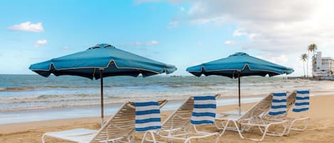 Beach nearby, white sand, beach umbrellas, beach towels