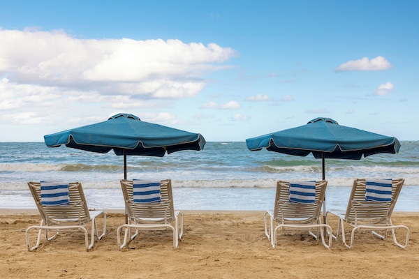 Beach nearby, white sand, beach umbrellas, beach towels