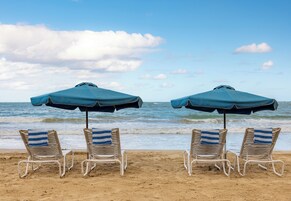 Beach nearby, white sand, beach umbrellas, beach towels