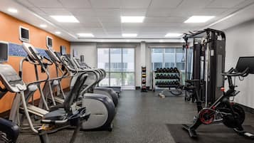 A gym with treadmills, a stationary bike, and weight machines.