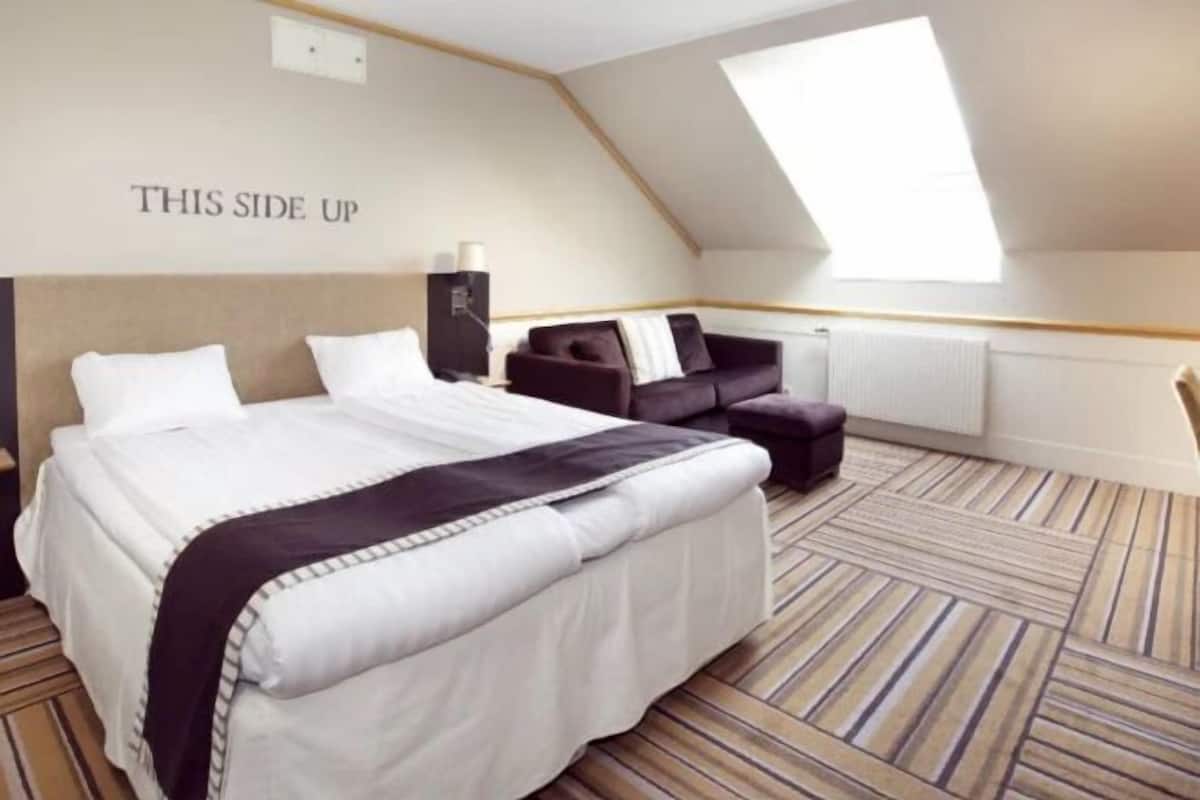 Desk, laptop workspace, iron/ironing board, bed sheets