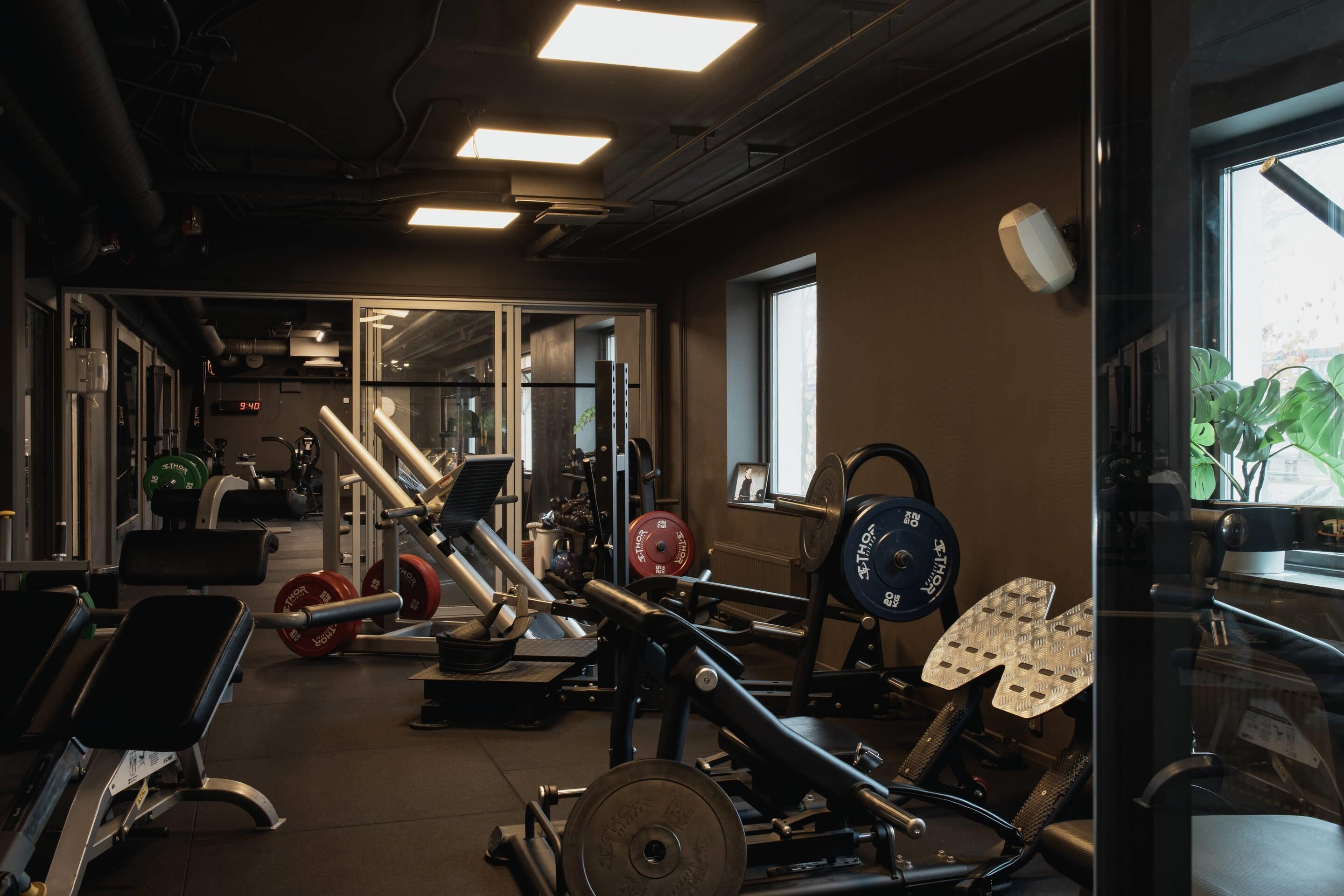 A gym with various exercise equipment, including weight machines and free weights.