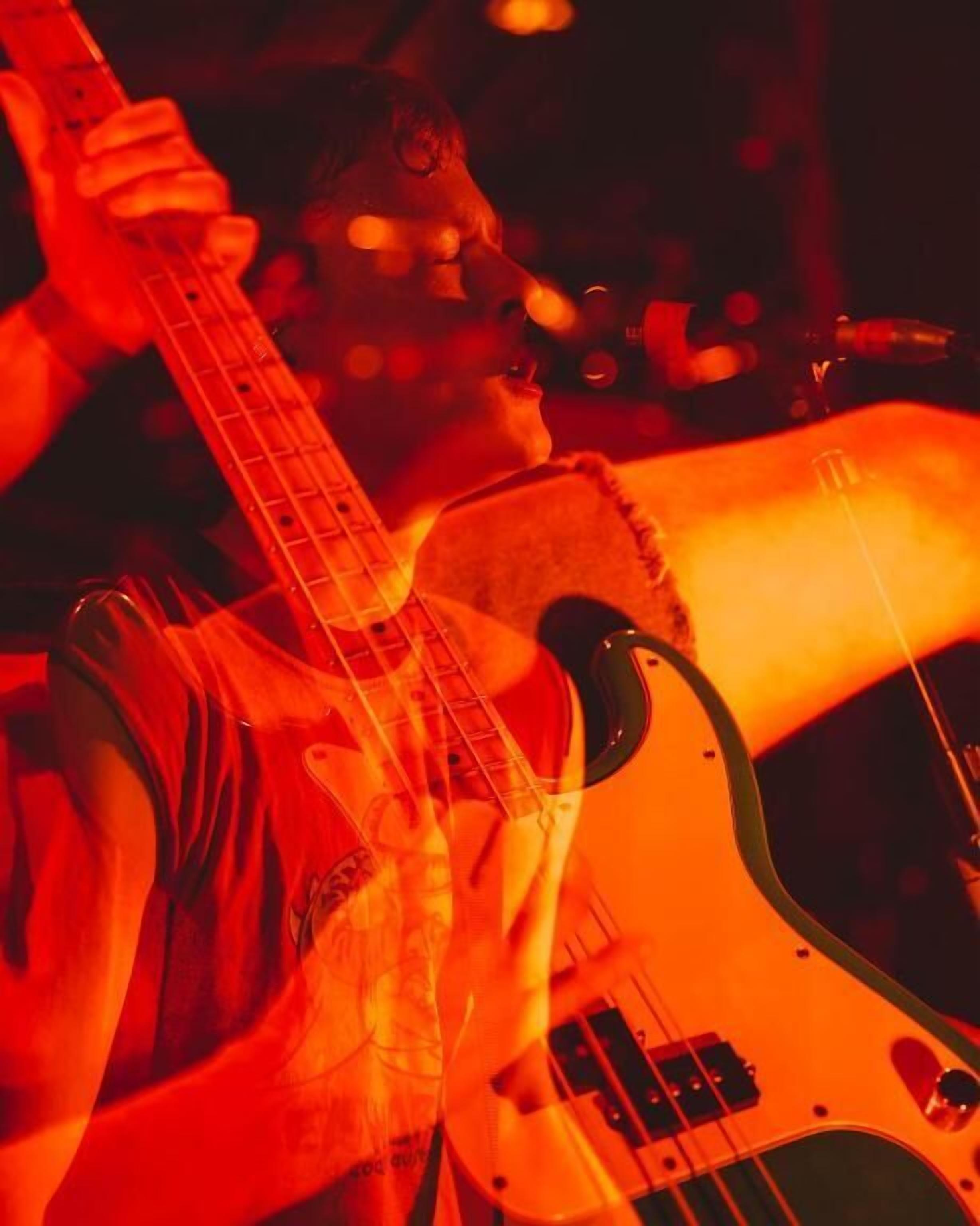 A person playing an electric guitar.