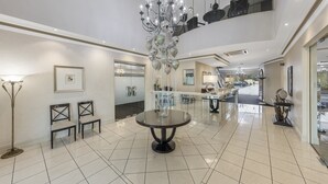 A spacious lobby with a chandelier, a round table, and a high ceiling. - The Carrington Hotel Shepparton (Shepparton)