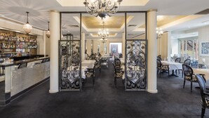 A spacious hotel lobby with a bar area, ornate chandeliers, and a view of the dining area. - The Carrington Hotel Shepparton (Shepparton)