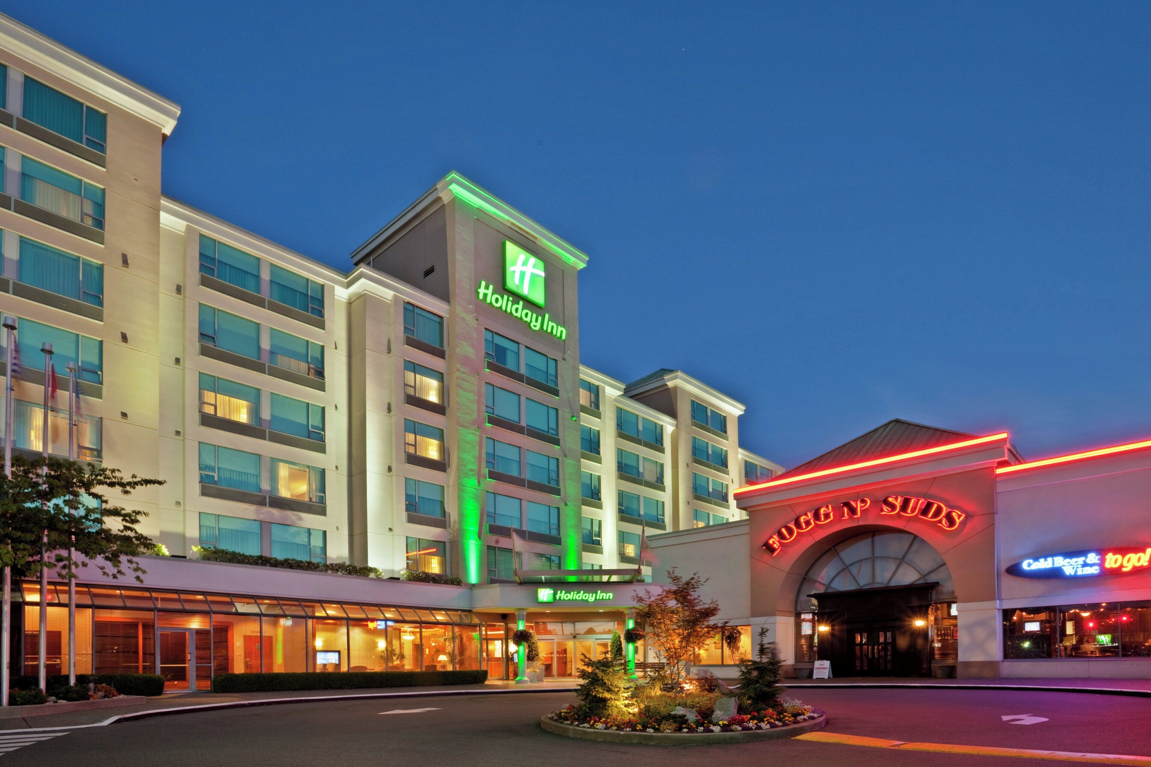 A Holiday Inn hotel with a modern facade, multiple floors, and a prominent entrance.
