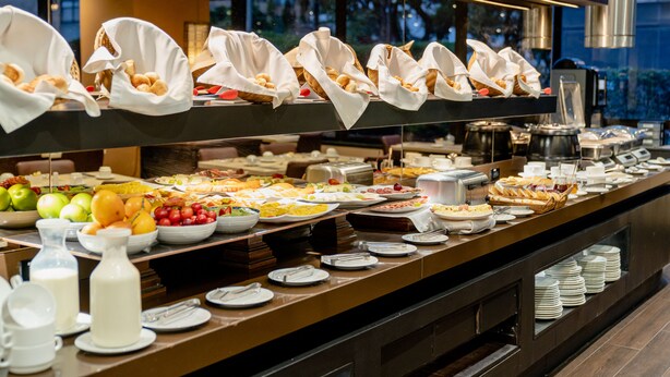 A buffet with various food items and beverages, including fruits, pastries, and dairy products. - 101 Park House (Bogotá)