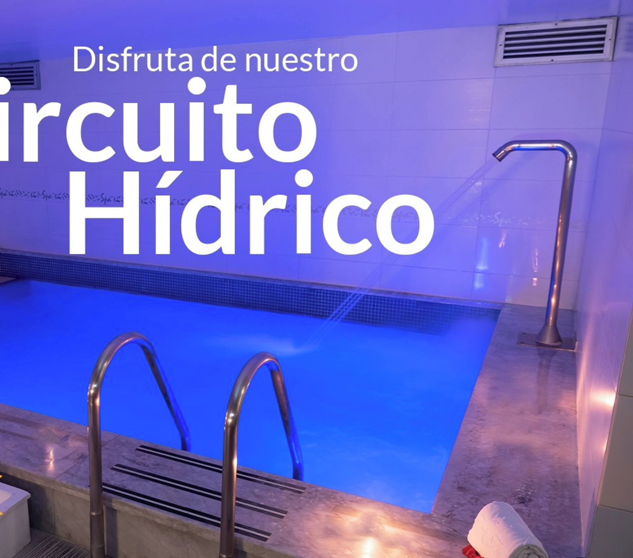 A swimming pool with a blue interior, metal handrails, and a towel on the edge.