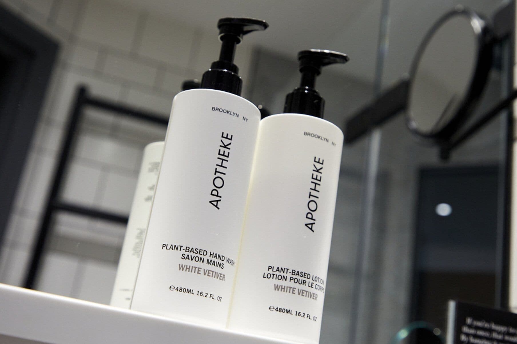 Two bottles of Apotheke plant-based hand wash on a shelf.