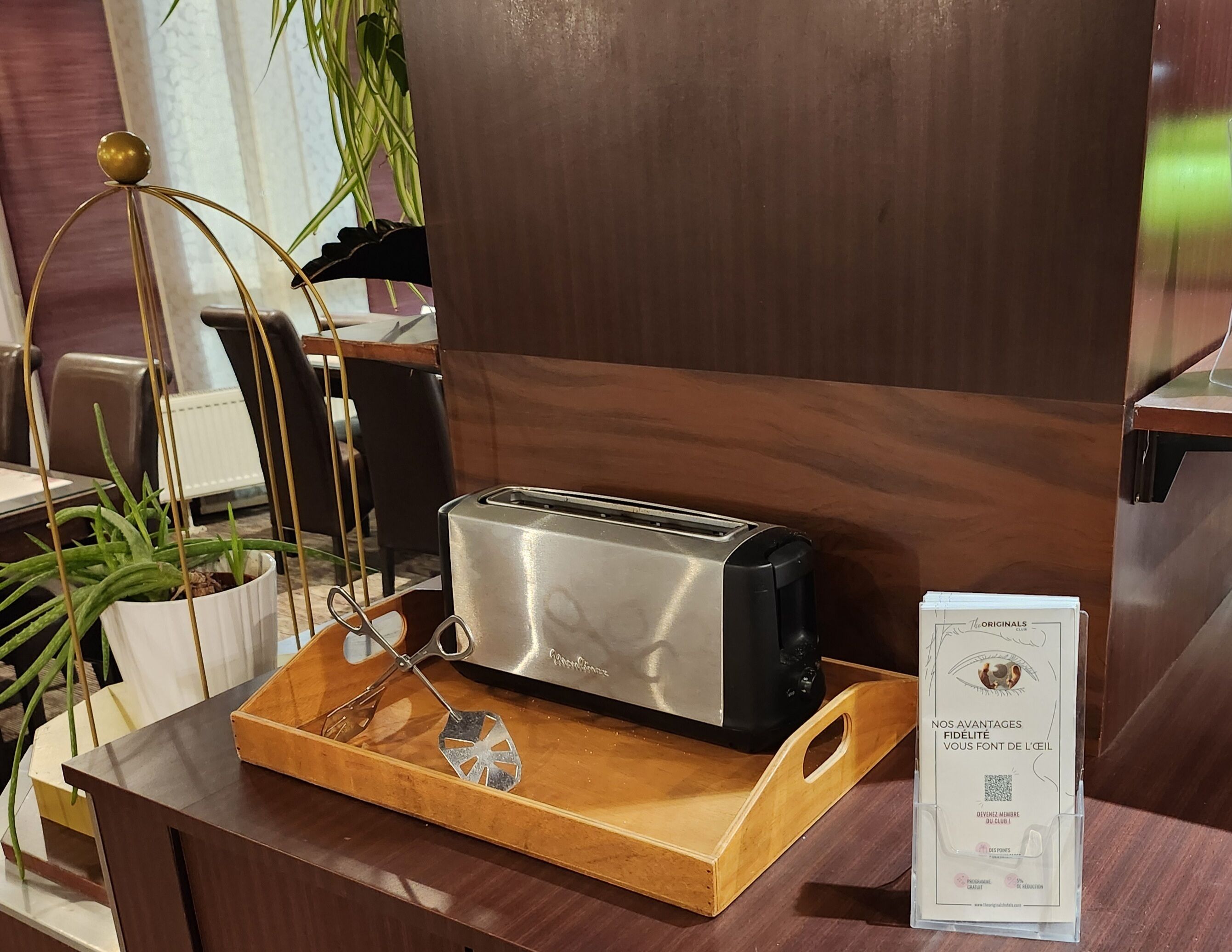 A wooden tray with a toaster and a pair of glasses on it.