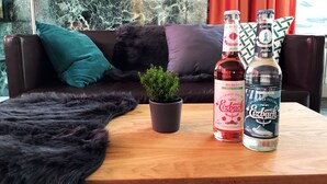 A wooden table with two bottles of rosé wine and a potted plant. - Golden Leaf Parkhotel Im Lehel (Munich)