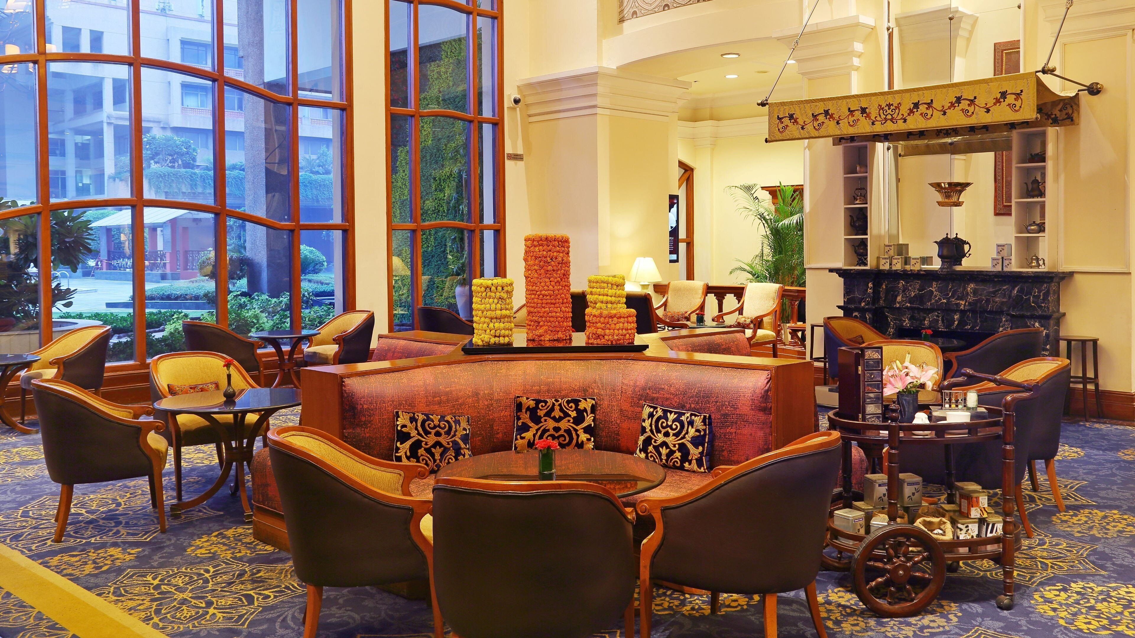 A hotel lobby with a large window, seating area, and a fireplace.