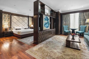A hotel room with a bed, a sofa, a coffee table, and a TV. - Eros Hotel New Delhi by IHG (New Delhi)