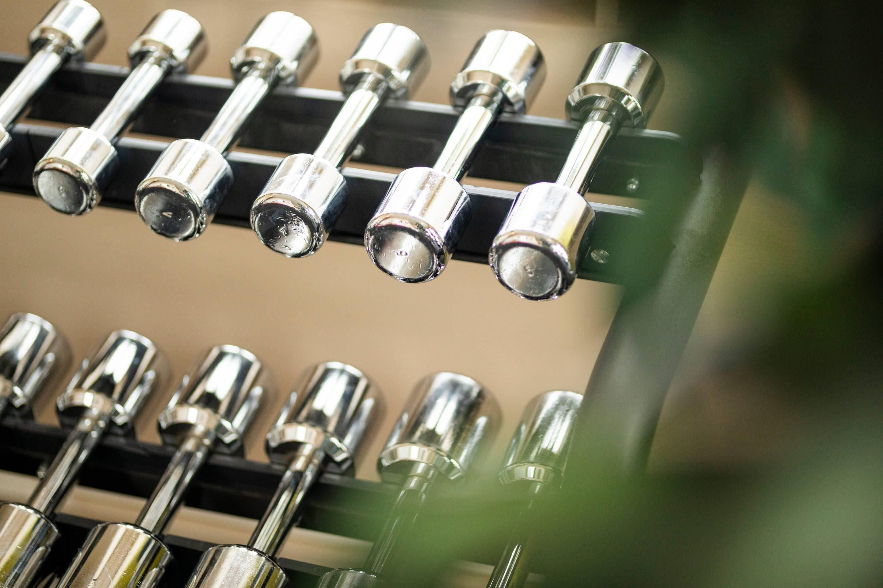 A series of metallic objects, likely equipment, arranged in rows on a black surface.