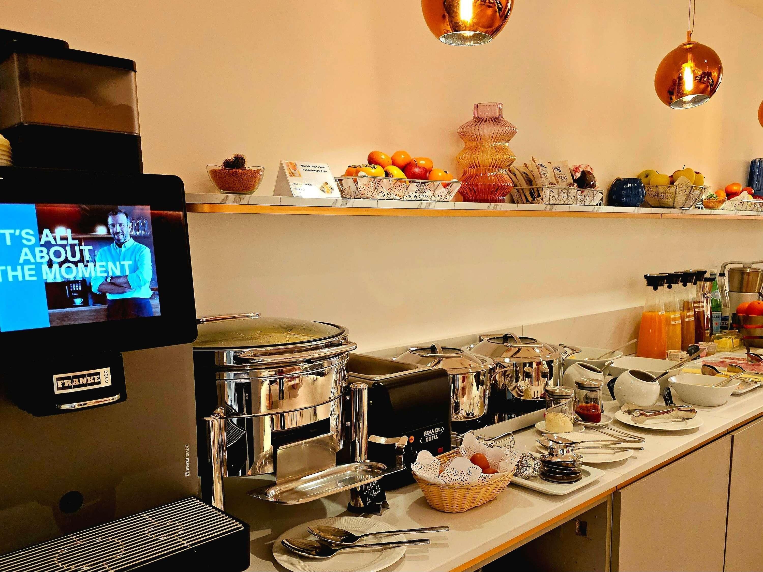 A buffet setup with various food items and a television screen displaying a message.