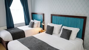A hotel room with two beds, each with a wooden headboard and grey bedding. - Rising Sun Hotel by Greene King Inns (Cheltenham)