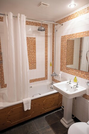 A bathroom with a shower, bathtub, and sink.