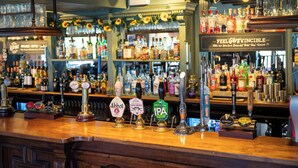 A bar with multiple beer taps, including brands like Abbott, Pale Ale, and IPA. - Rising Sun Hotel by Greene King Inns (Cheltenham)
