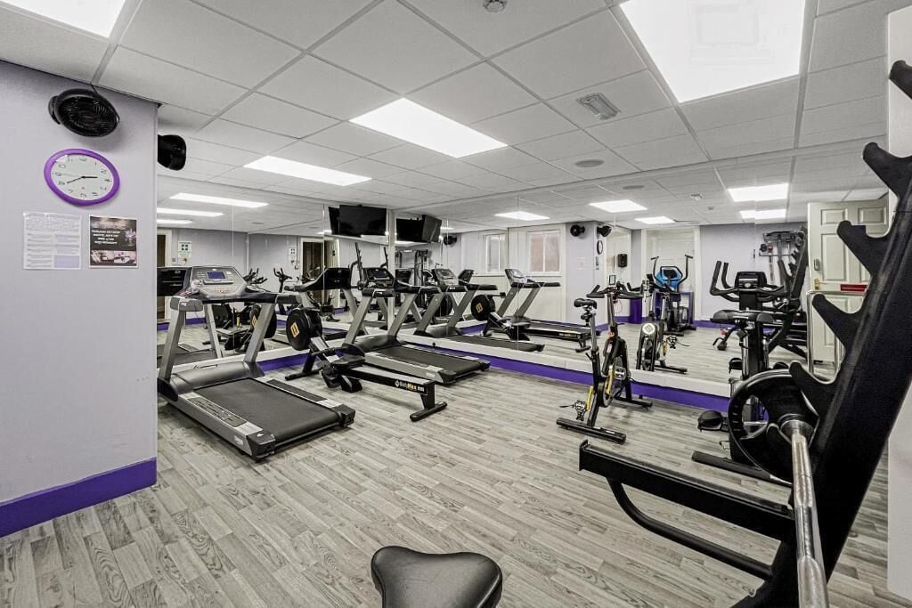 A gym with treadmills, stationary bikes, and weight machines.