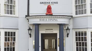 A building with a sign reading "The Red Lion" and "Bar & Dining" indicating it is a pub.