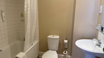 A bathroom with a bathtub, toilet, and sink.