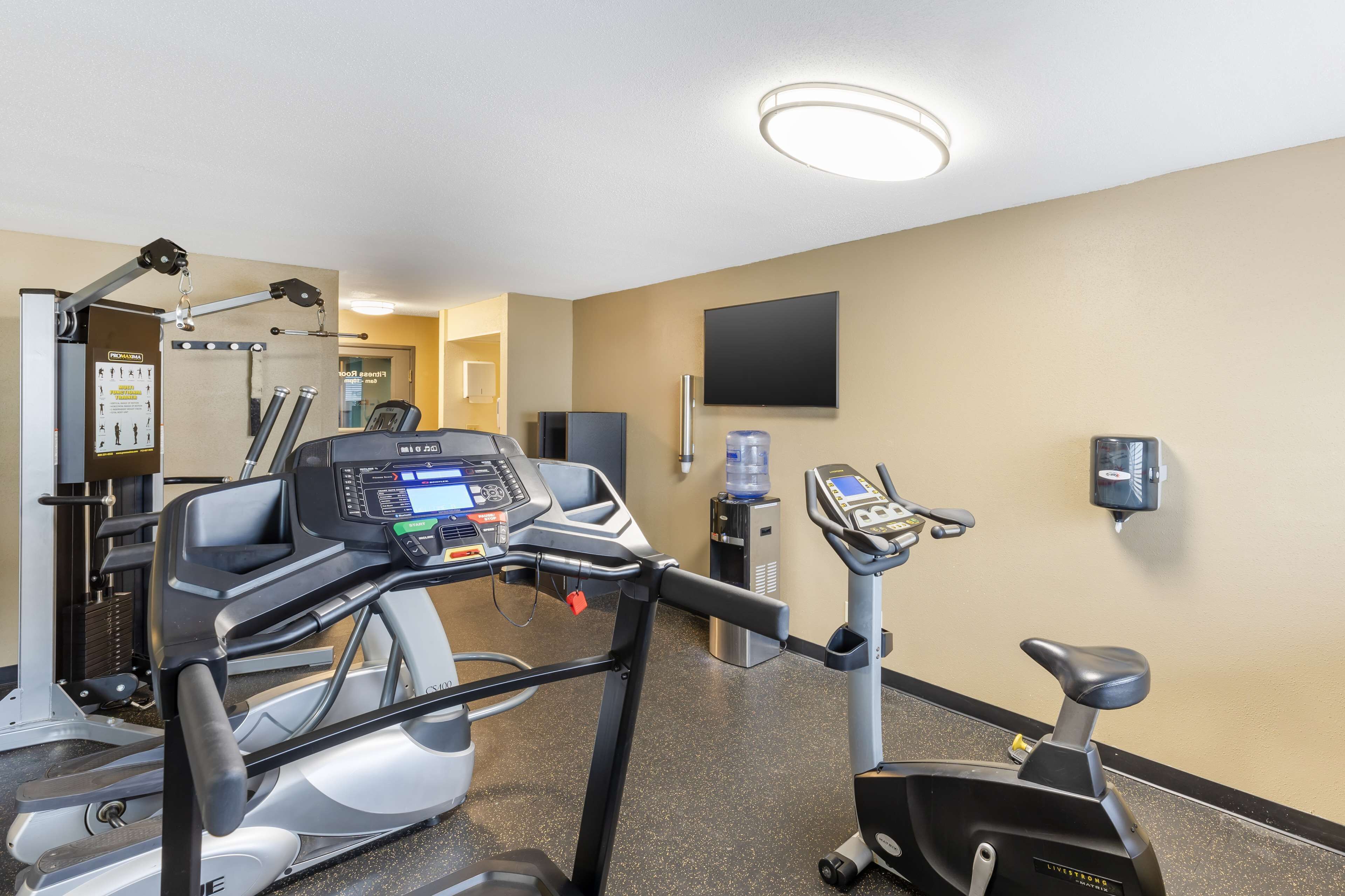 A gym with treadmills, stationary bikes, and weight machines.