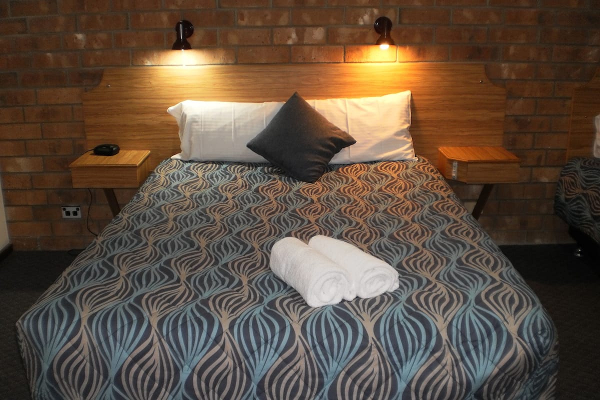 Escritorio, cortinas blackout y tabla de planchar con plancha
