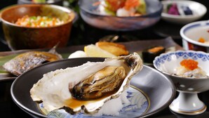 A variety of dishes including seafood and a bowl of soup.