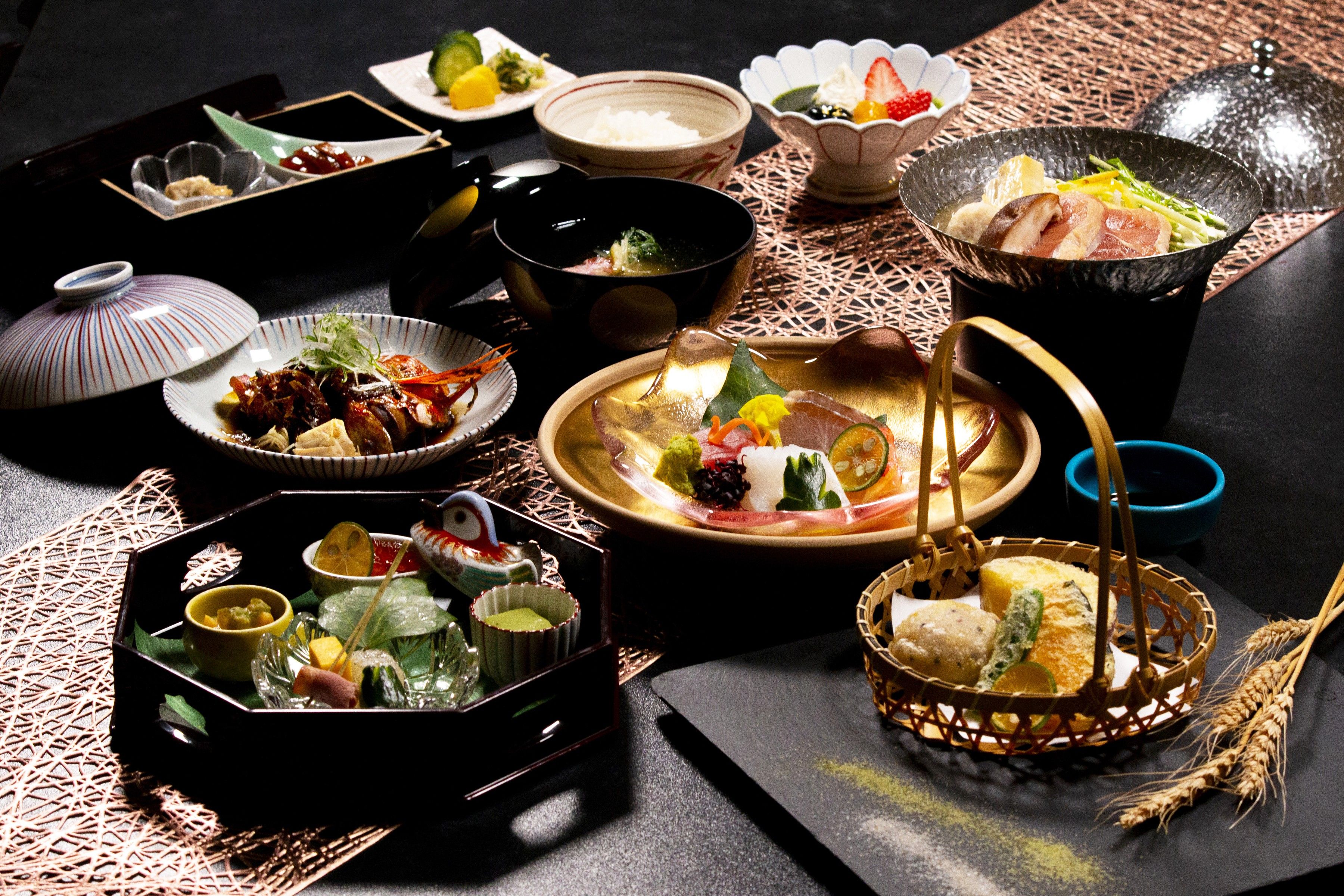 A variety of dishes and bowls on a table, suggesting a meal setting.