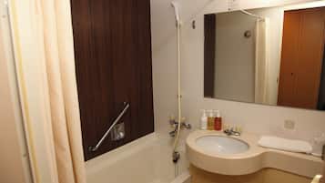 A bathroom with a bathtub, a sink, and a mirror.