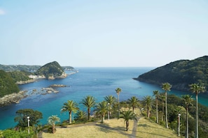 Enjoy breathtaking views of the sea and surrounding hills from this serene coastal setting.