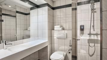 A modern bathroom with a white sink, a toilet, and a shower.