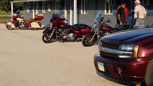 A motel with a parking lot. There are several motorcycles parked in the lot. - Burr Oak Motel (Algona)