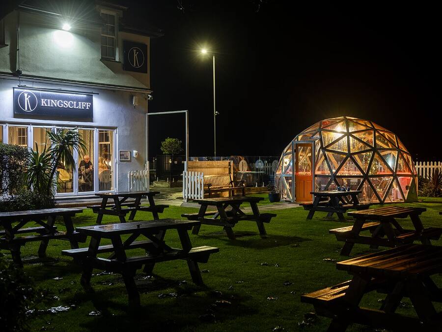 A Kingscliff restaurant with outdoor seating and a geodesic dome structure.