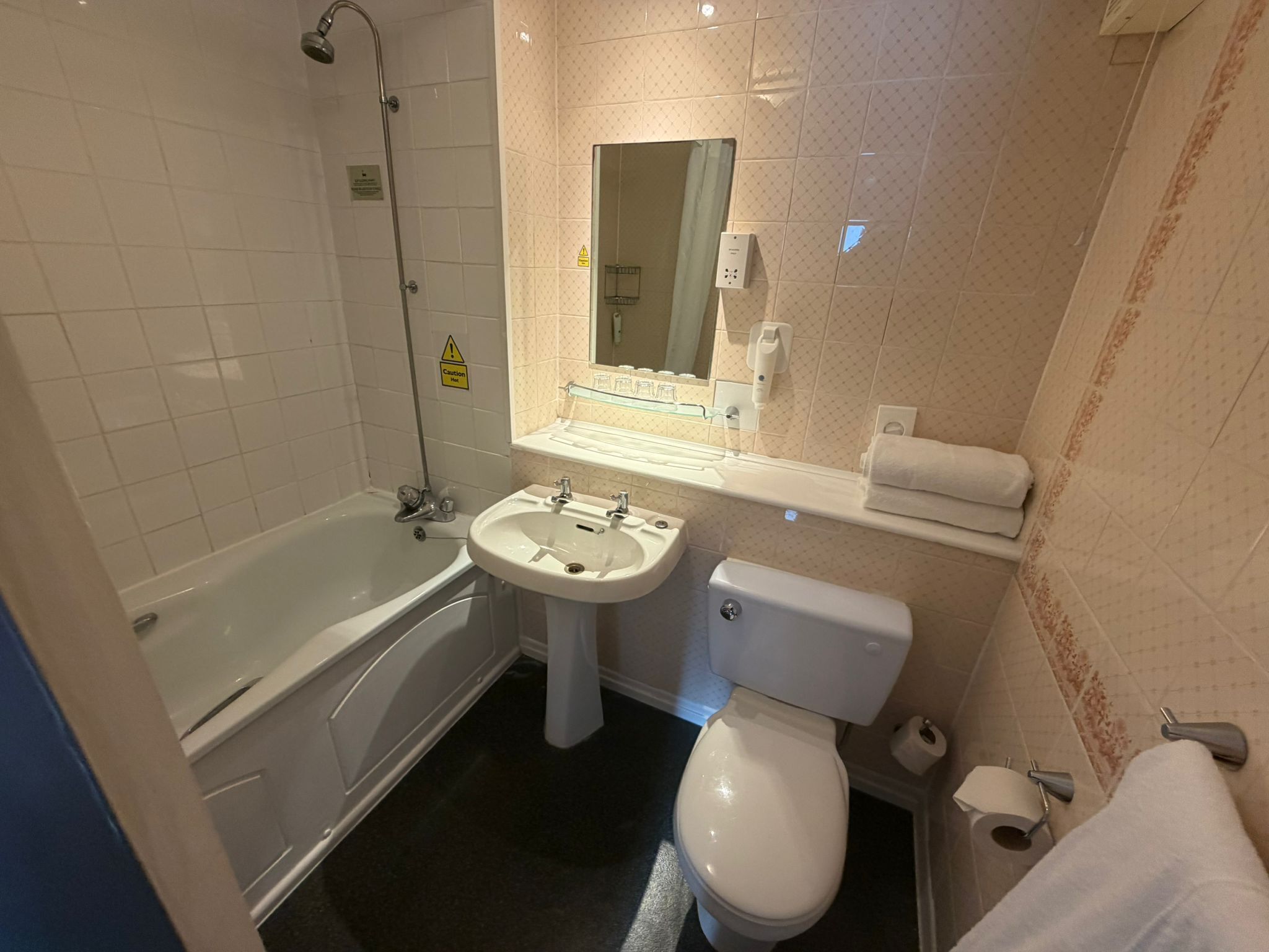 A bathroom with a bathtub, sink, toilet, and a shower.