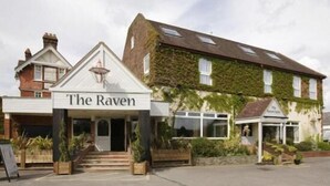 A building with a sign reading "The Raven" and a traditional architectural style with a gabled roof and brickwork. - The Raven Hotel by Greene King Inns (Hook)