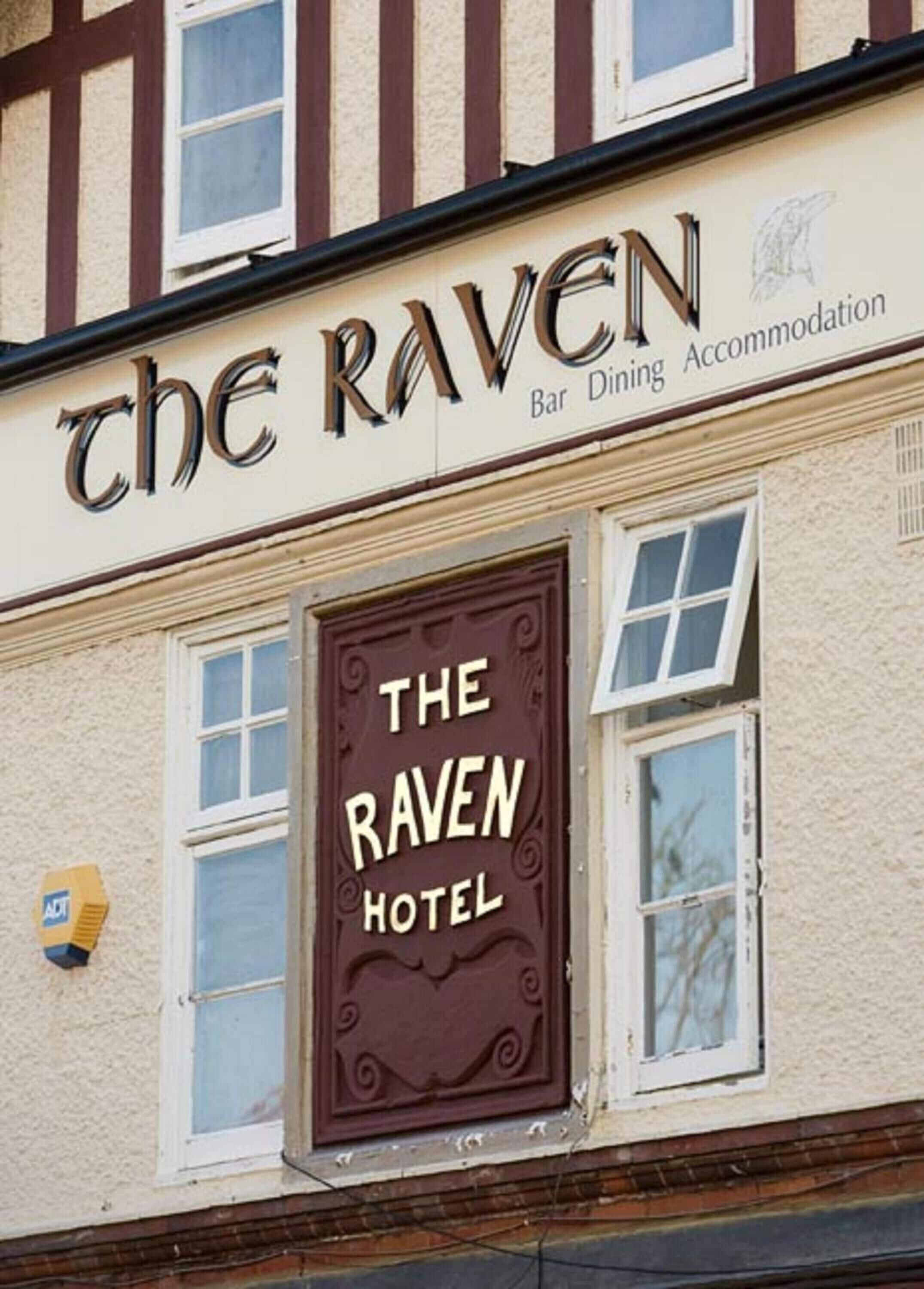 A building with a sign that reads "The Raven Hotel Bar Dining Accommodation."