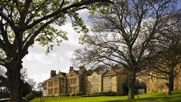 A large, historic stone building with multiple windows and a well-maintained lawn. - Hollins Hall Hotel, Spa & Golf (Shipley)