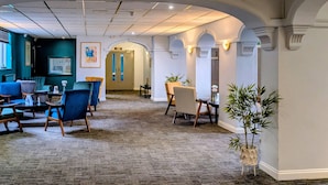 A hotel lobby with seating areas, a reception desk, and a reception area. - Quality Hotel Coventry (Coventry)