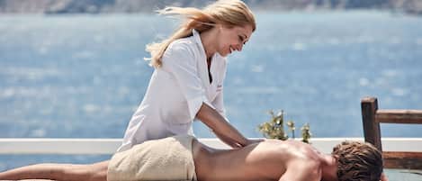 A massage therapy session by a poolside with a scenic view.