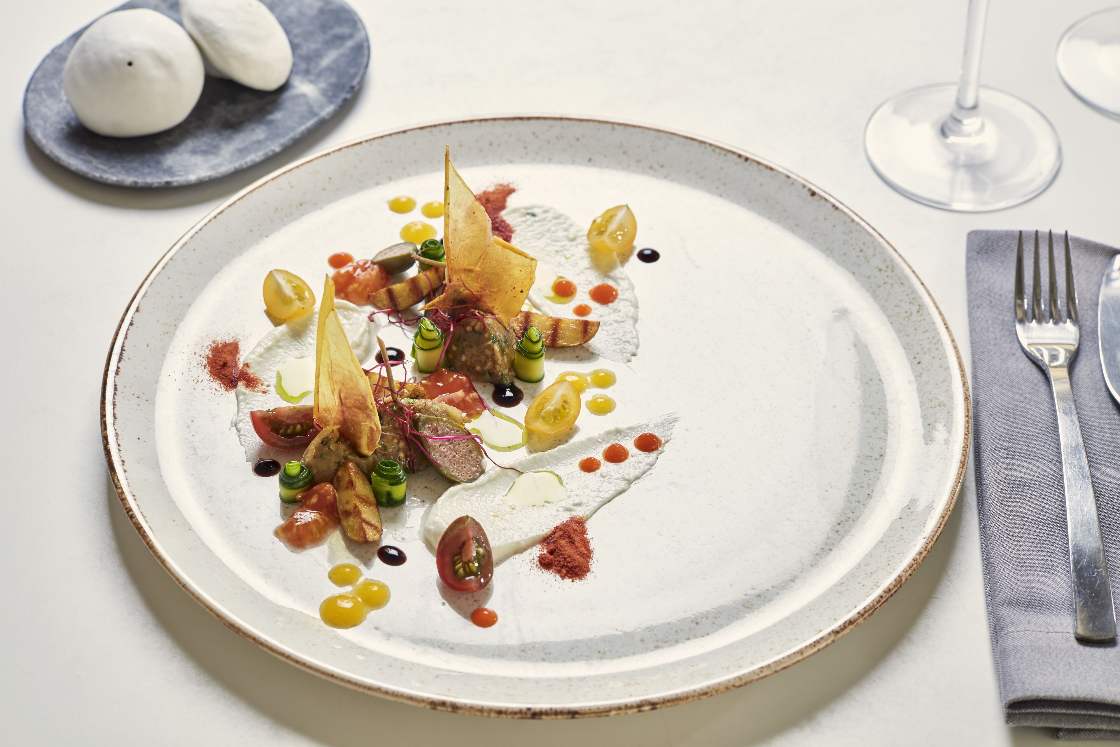 A plate of food with various garnishes and sauces.