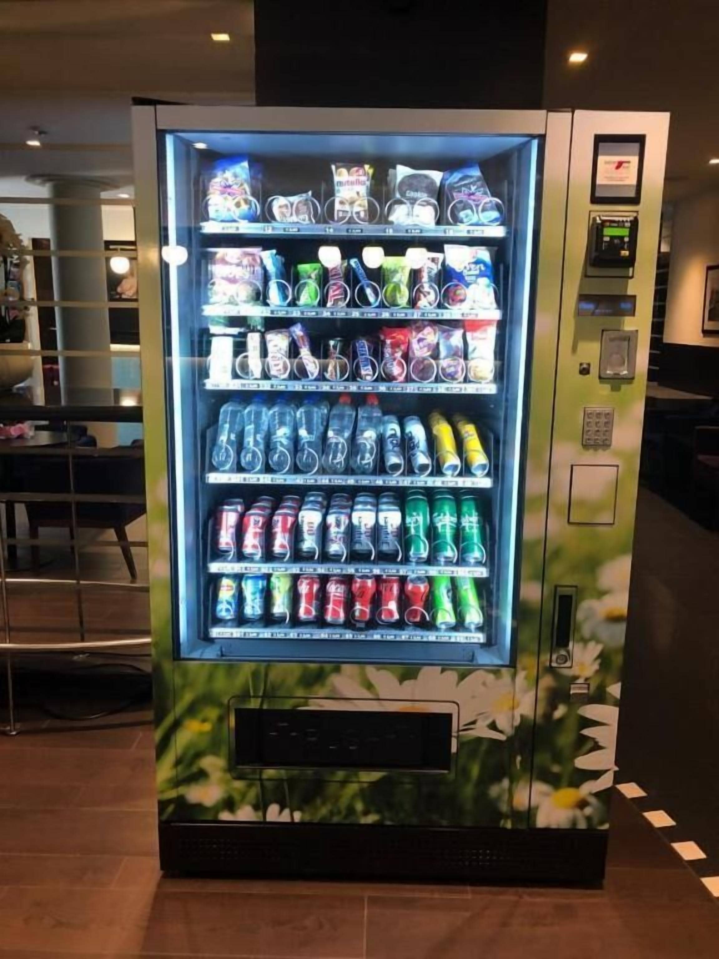A vending machine with various snacks and drinks, including chips, candies, and bottled beverages.