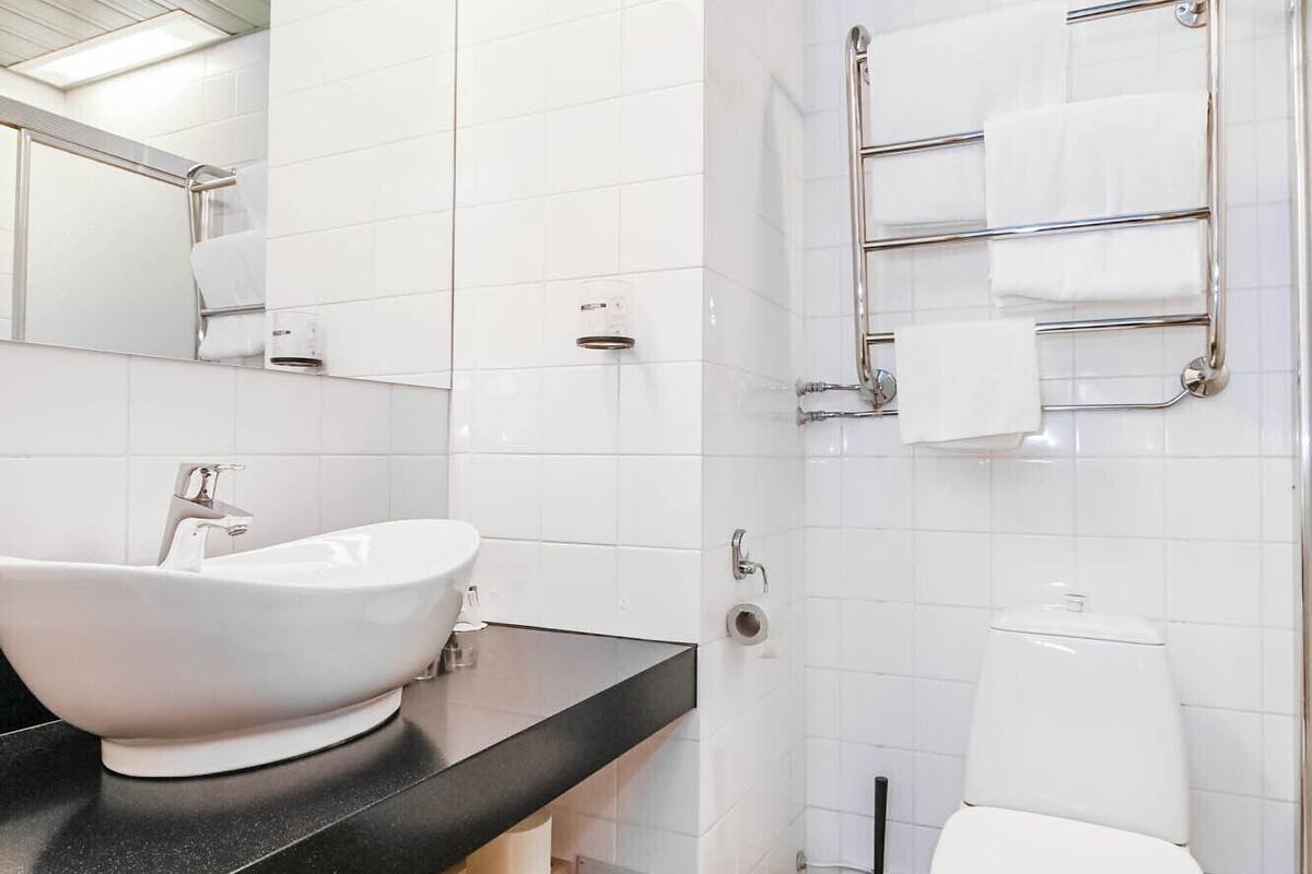 shower, hair dryer, slippers, towels