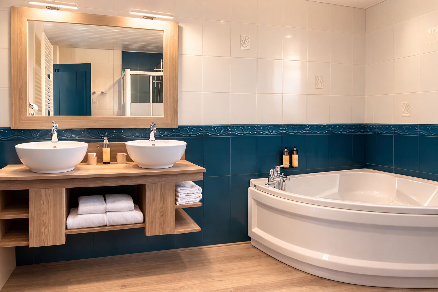 A bathroom with two sinks, a large bathtub, and a mirror above the sinks.