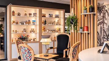 Un intérieur chaleureux, avec des meubles en bois, une table, des chaises, une lampe et des étagères remplies de divers objets.