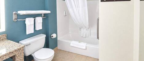 A bathroom with a toilet, sink, and bathtub.