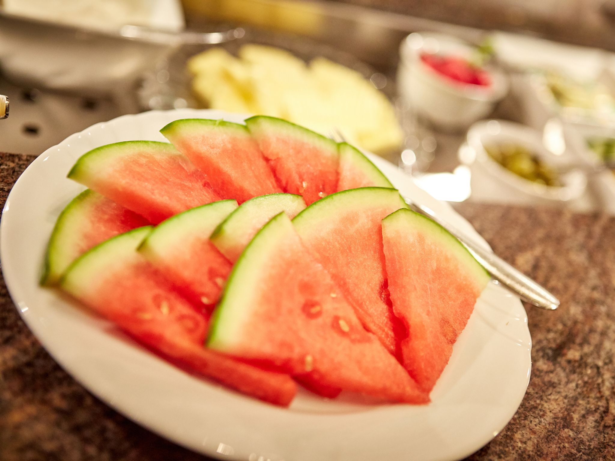 A plate of watermelon slices on a countertop.